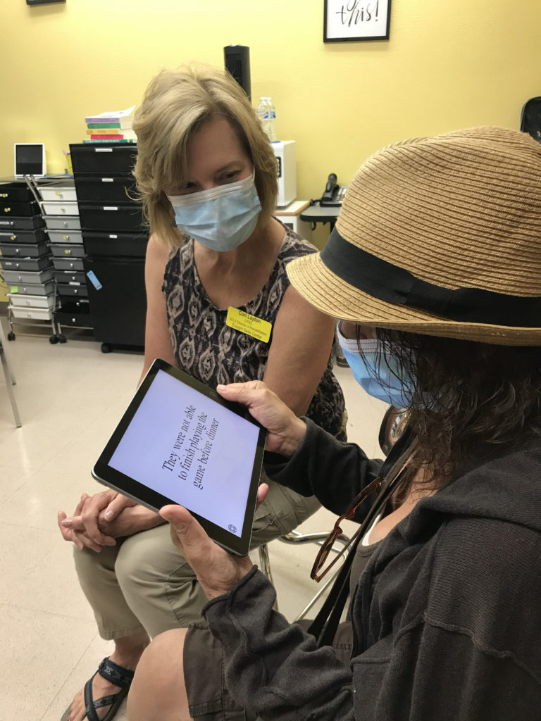 Cori Layton helps CFI consumer Joyce with a Low Vision evaluation